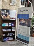 Photo of a woman and two boys looking at Reginna 4.0 fliers. In front of them is an interactive display screen.