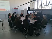 A group photograph of sixteen next to a presentation slide titled "Training agenda".