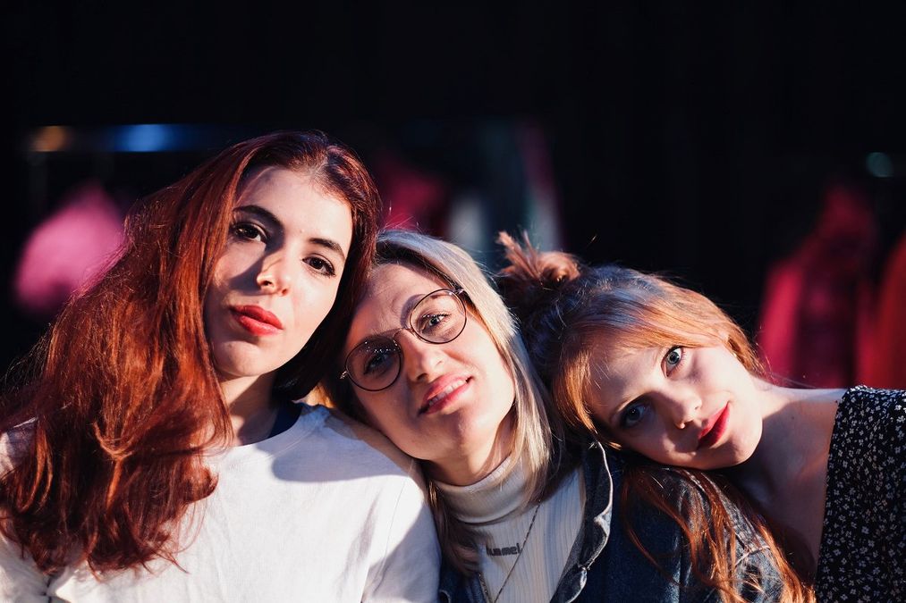 Photograph of three women looking at the camera.