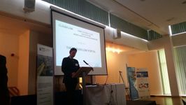Photograph of a precentor giving a presentation to the audience.