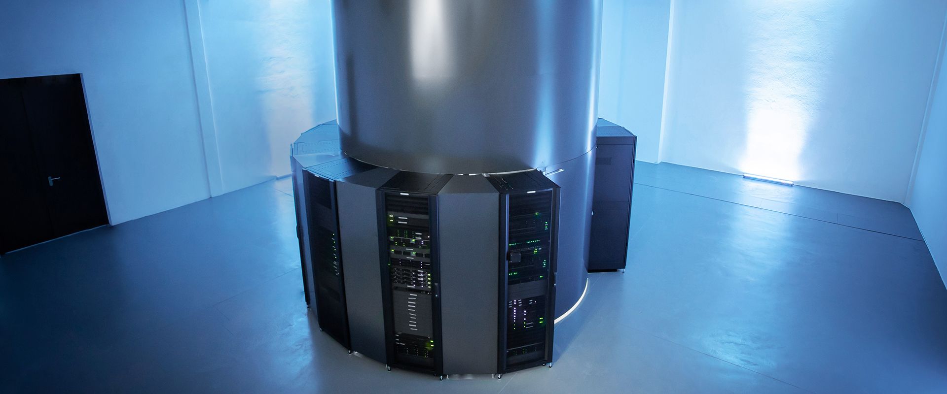 Photograph displaying a giant supercomputer with several cooling units and cables visible that help perform complex scientific and research calculations at the Arctur company.
