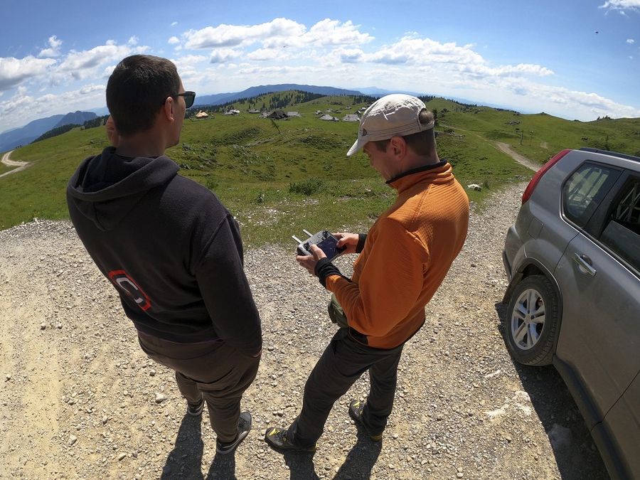 Photograph at Velika Planina of two Arctur employees testing a drone.