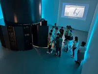 A group of students is being given a tour of Arctur's supercomputer.