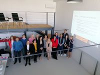 A group photograph of sixteen next to a presentation slide titled "Training agenda".