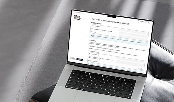 Laptop displaying municipal tender procedures web application.