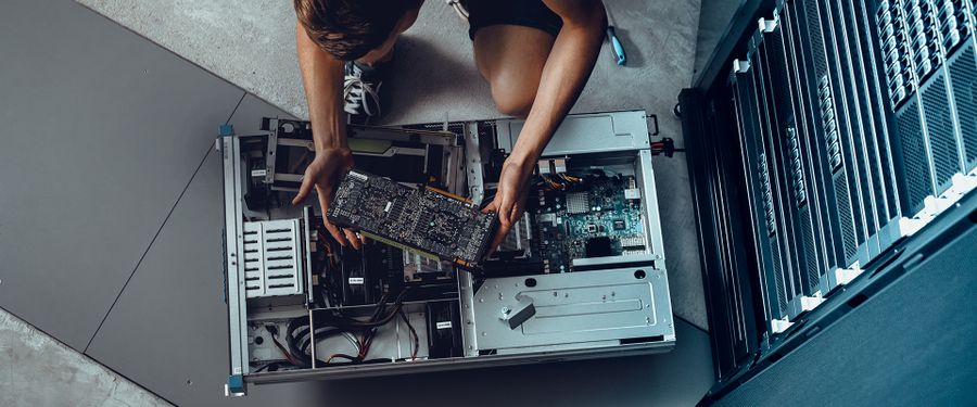 An IT engineer inserting components into Arctur's supercomputer.