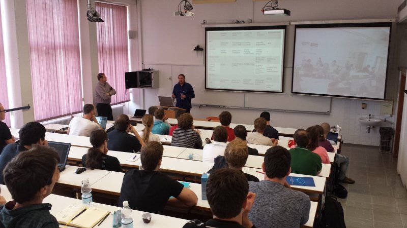 The presenter is giving a presentation to the students.