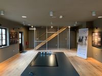 A museum room with a horizontal Staucharia Ironworks Interactive OR table.