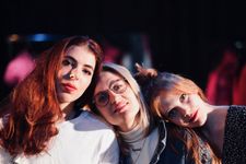 Photograph of three women looking at the camera.